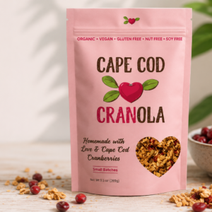 Cape Cod Cranola handcrafted organic cranberry granola package on a rustic kitchen table.